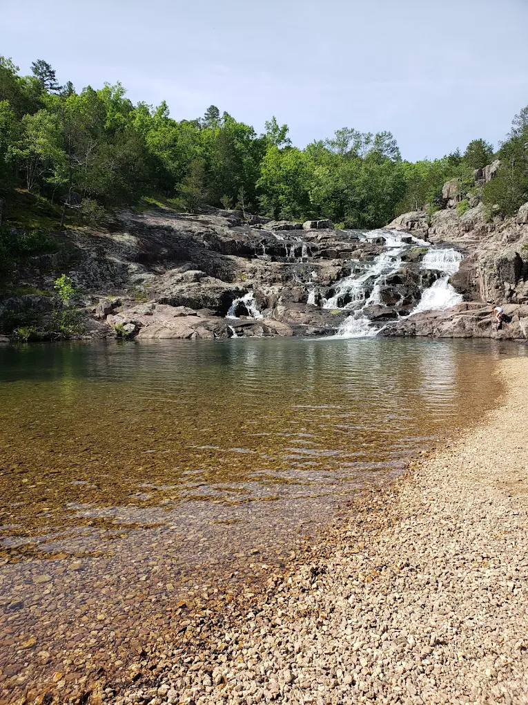 Rocky waterfall and clear swimming area in the Missouri Ozarks